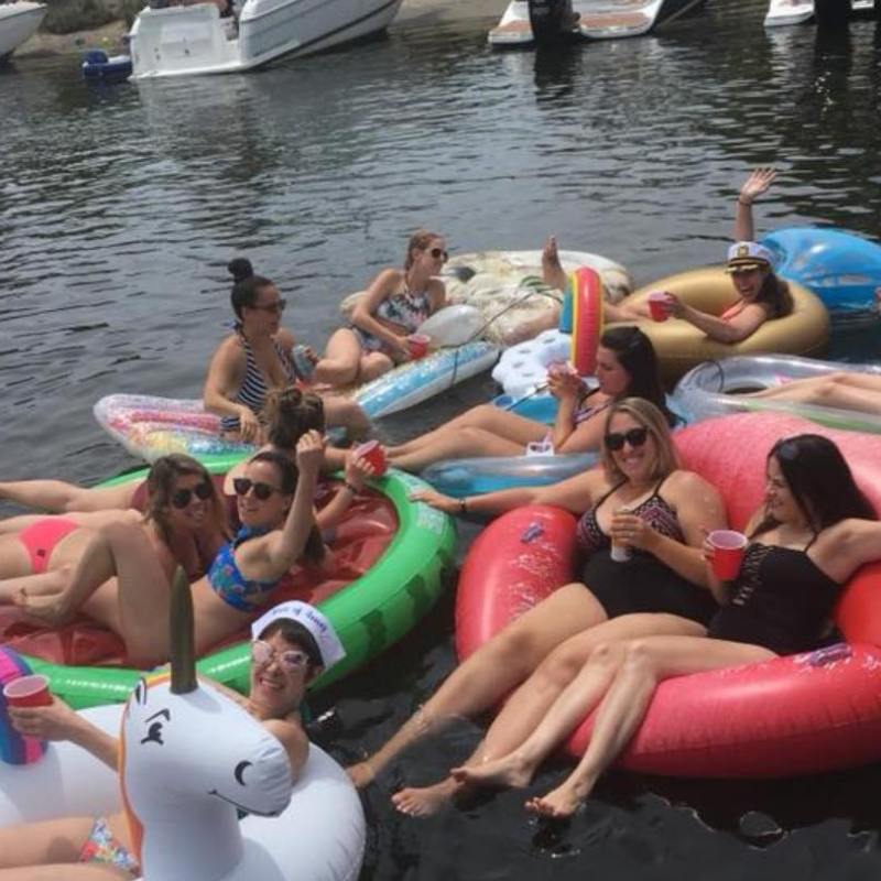 a group of people sitting on a raft in a body of water